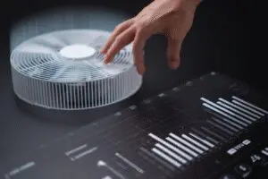 A hand adjusting sliders to change a fans speed a guide for how to control fans on a PC