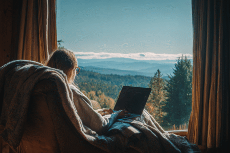 A person gaming on a laptop in a comfortable scenic spot asking are gaming laptops worth it