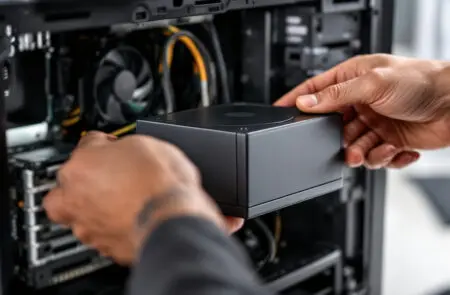 a persons hands installing a new power supply unit psu into a computer case