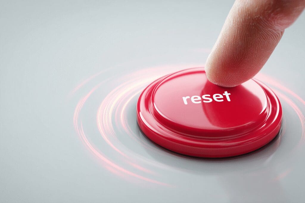 A finger pressing a large reset button illustrating the answer to the FAQ on how to reset a graphics card